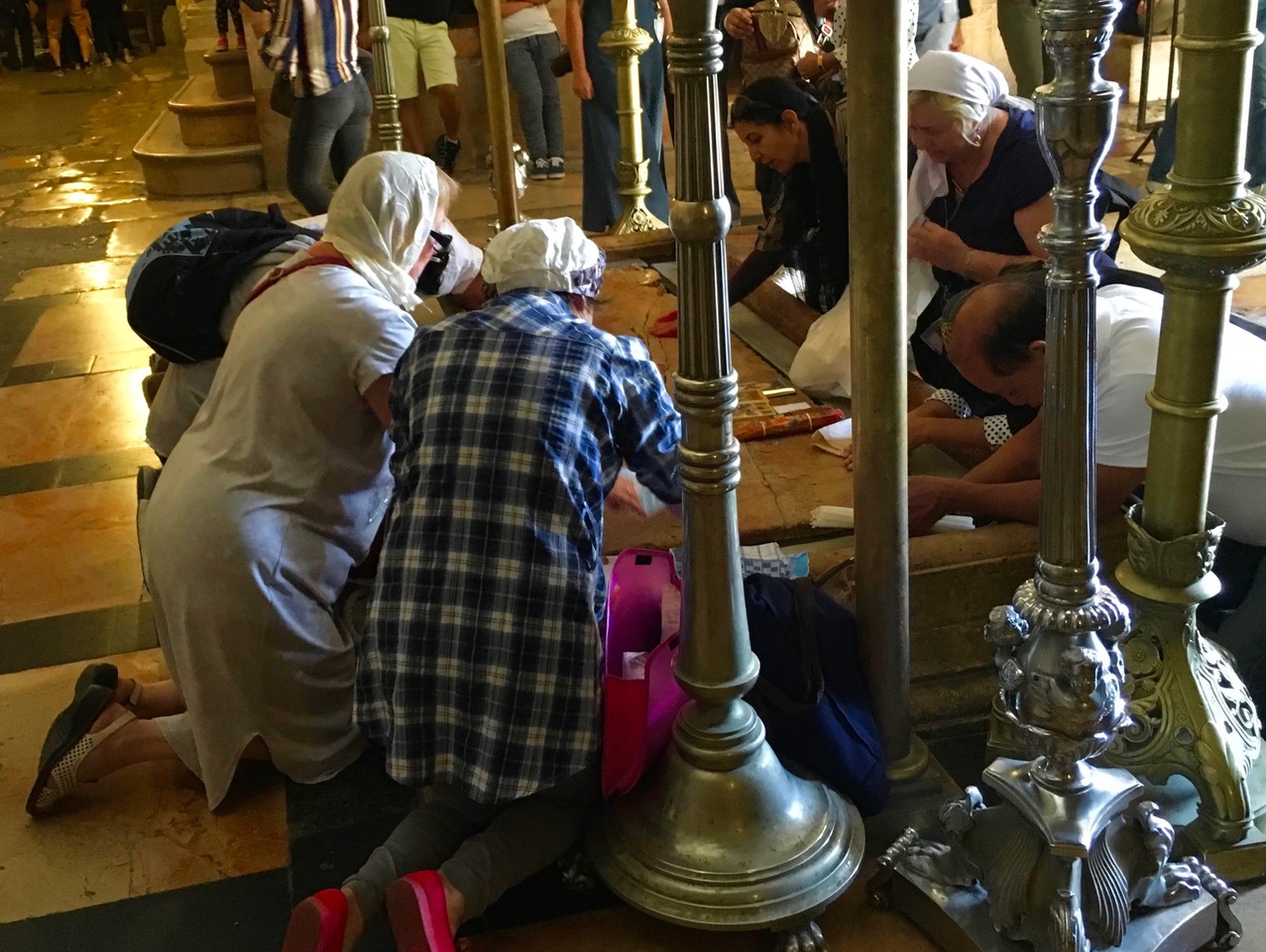 Church of the Holy Sepulchre - pilgrims pray at the Anointing Stone